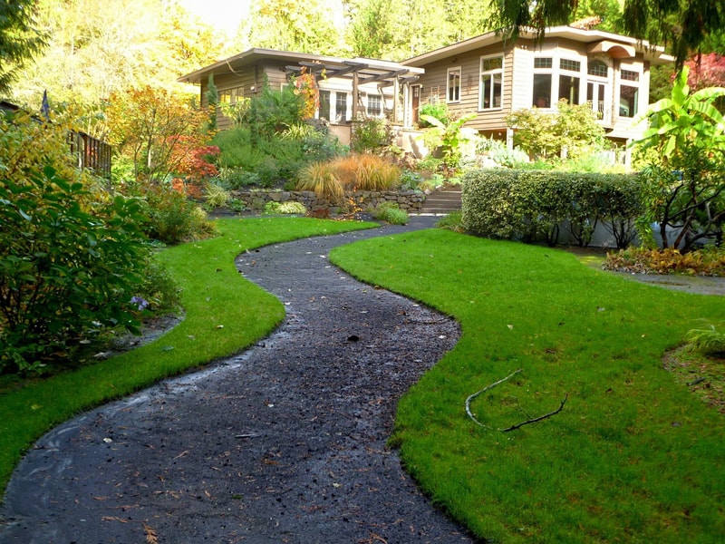 This simple path to the house, winding its way through lush green landscape is the perfect addition to the secluded location of this home..