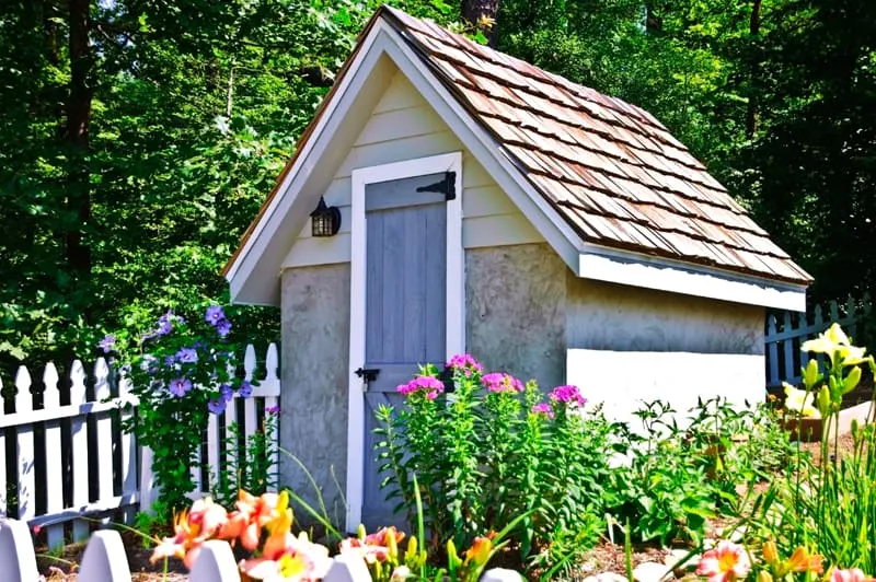 small garden shed with flowers