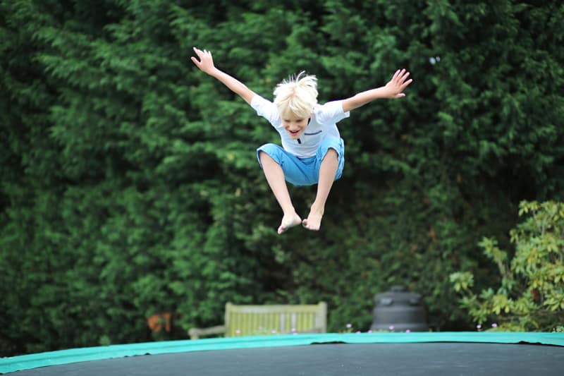 young boy jumping on the trampoline
