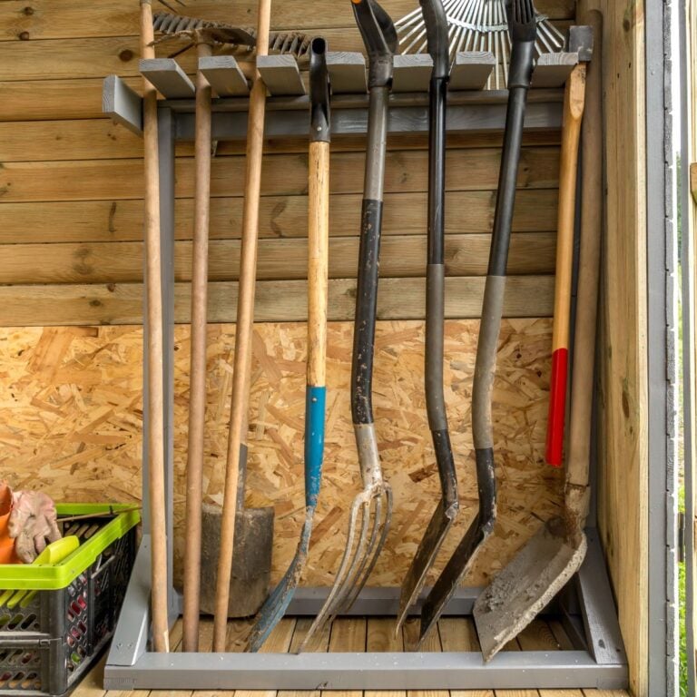 Wooden rack with garden tools and equipment for an organized shed.