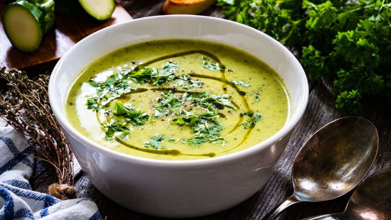 Cream zucchini soup on wooden table