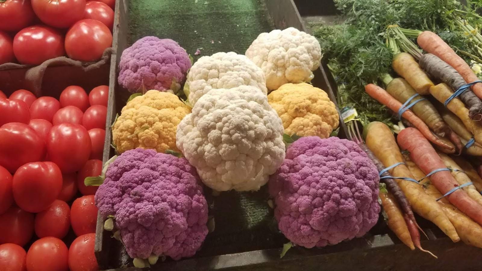 tomatoes, cauliflower and carrots for sale at the farmer's market.