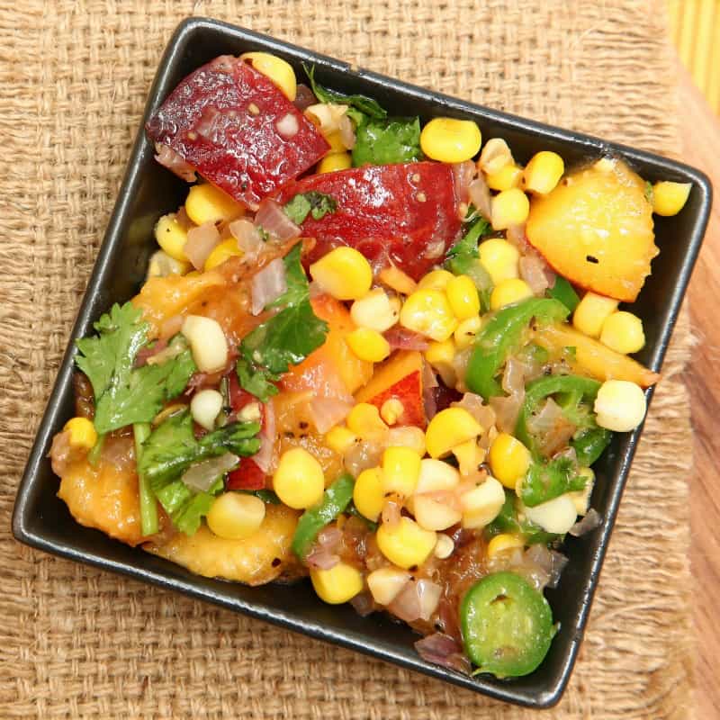 Peach and corn salsa on table, ready to eat.