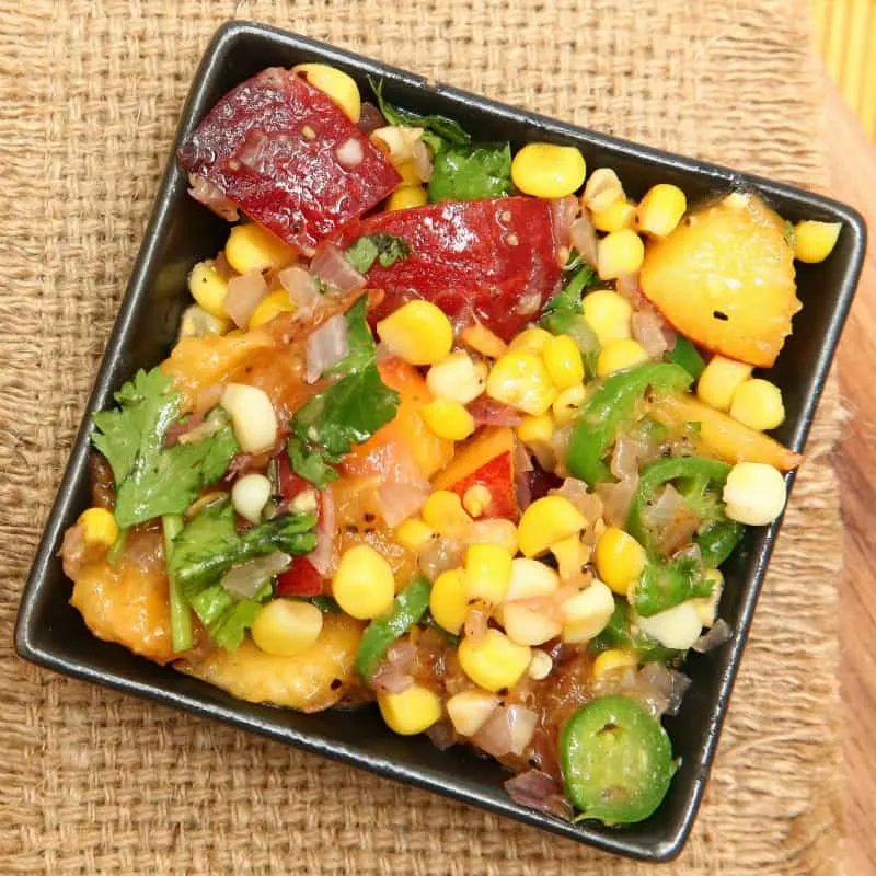 Peach and corn salsa on table, ready to eat.