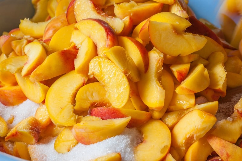 Ripe peach fruit slices with sugar
