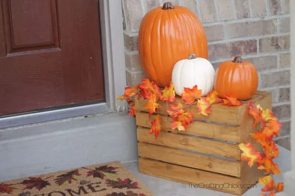 Autumn porch decorated with pumpkins