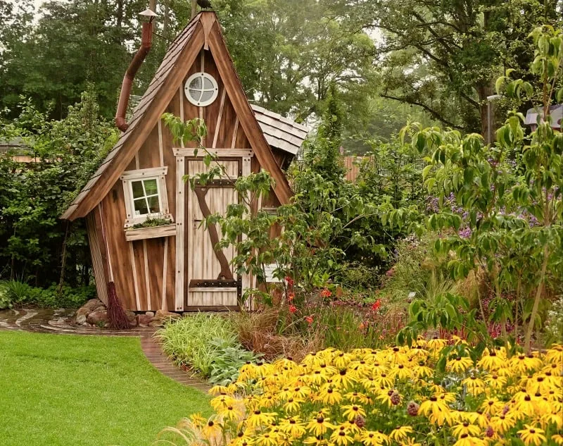 Cedarwood shed surrounded by flowers