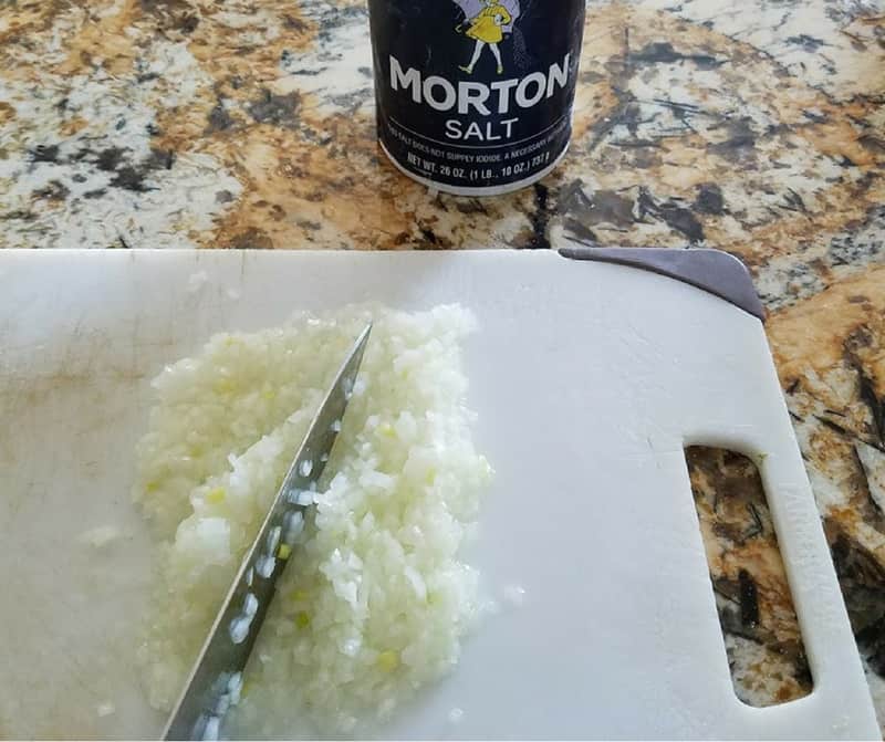 chopped onions of a white cutting board