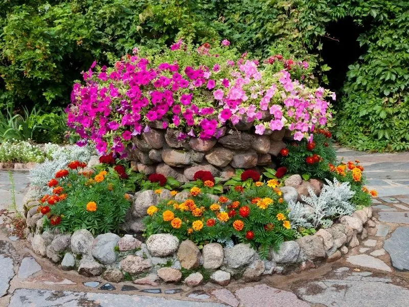 a flower bed made from big rocks