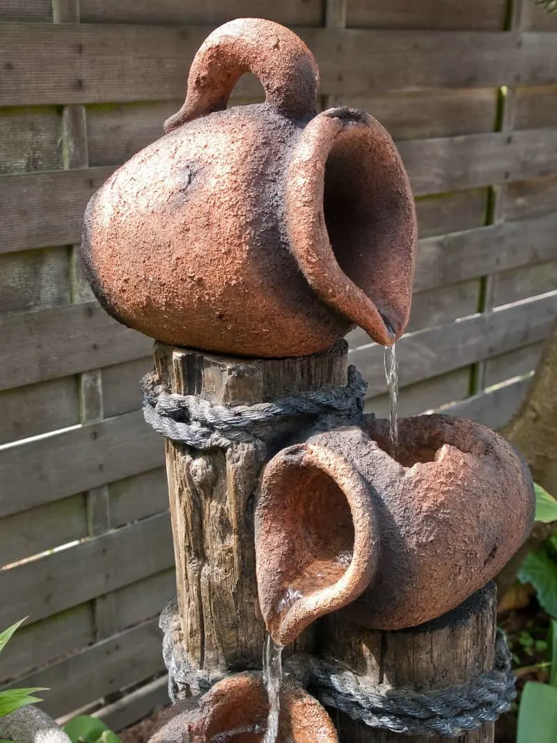 Decorative garden waterfall pond made of stone jars