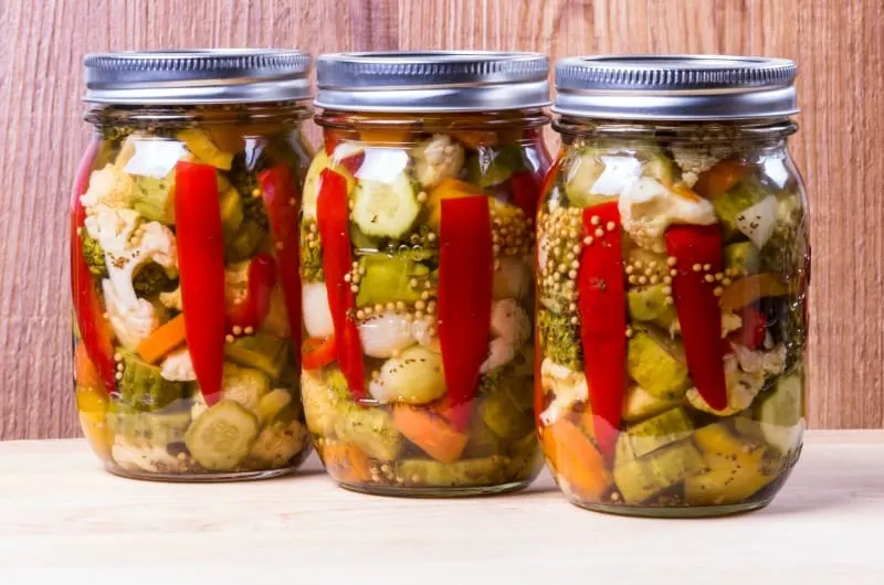 Three jars of homemade preserved hot mixed vegetables