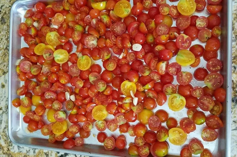 Sheet pan of cherry tomatoes ready to roast