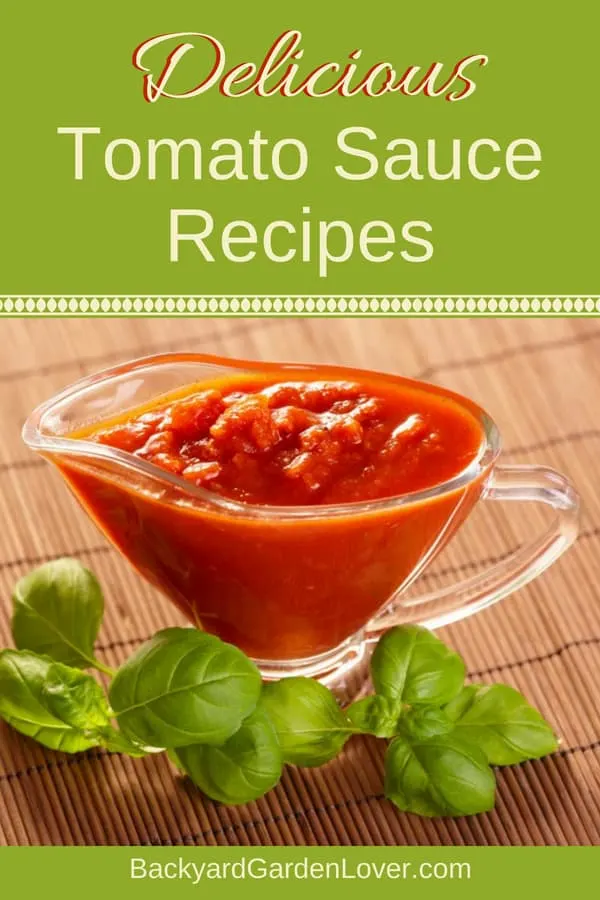 A bowl of tomato sauce surrounded by basil leaves 