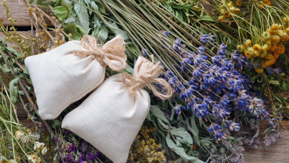 Dream pillows with some lavender flowers behind them.