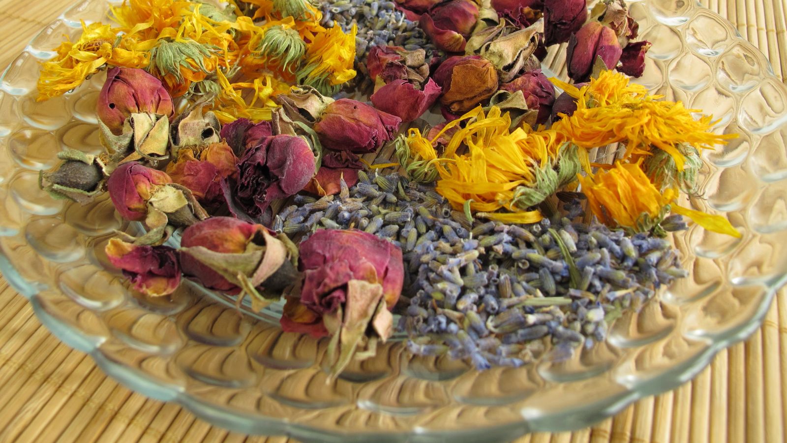Dried flowers potpourri, including lavender, rose, and calendula flowers.