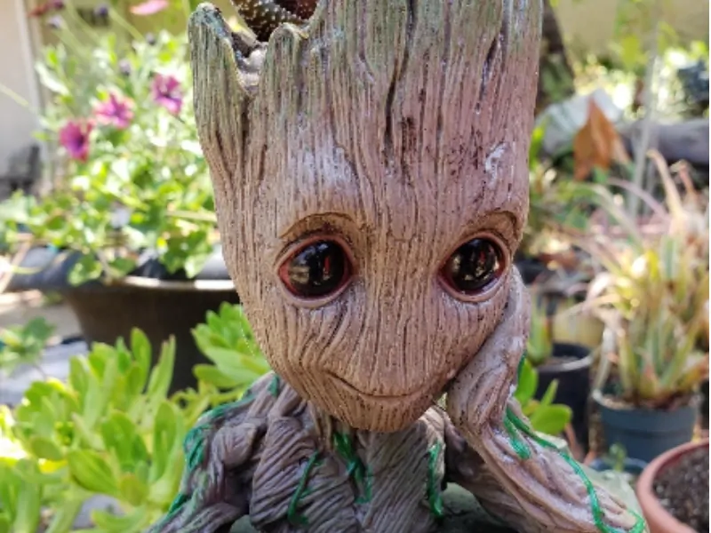 Adorable baby groot flower pot sitting on my patio table