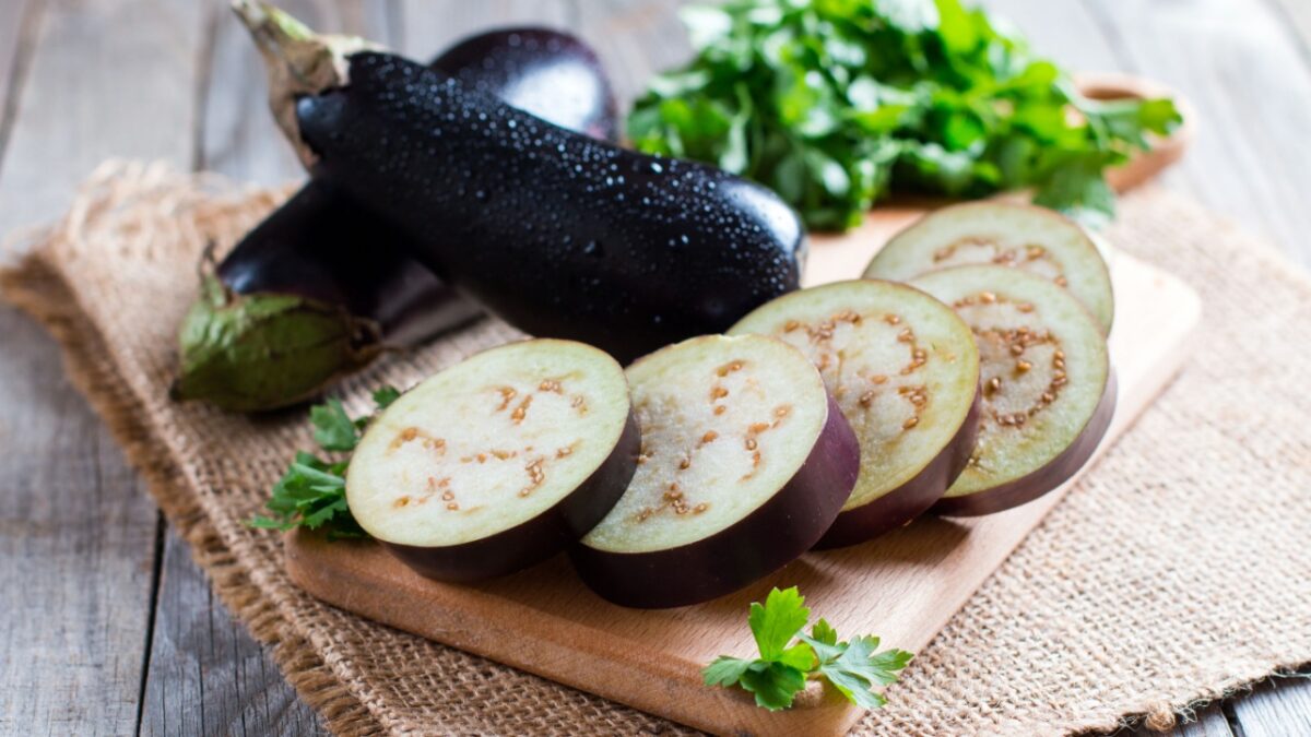 Sliced eggplant on wooden cutting board