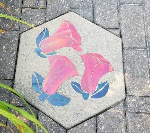 Pink bell shaped flowers on a stepping stone