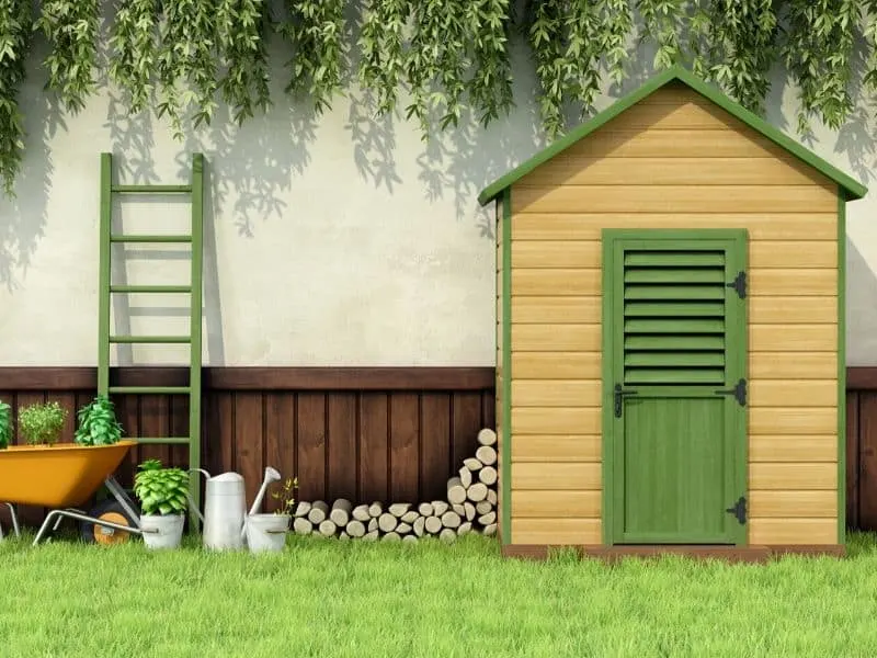 Beautiful backayard garden shed trimmed with green paint