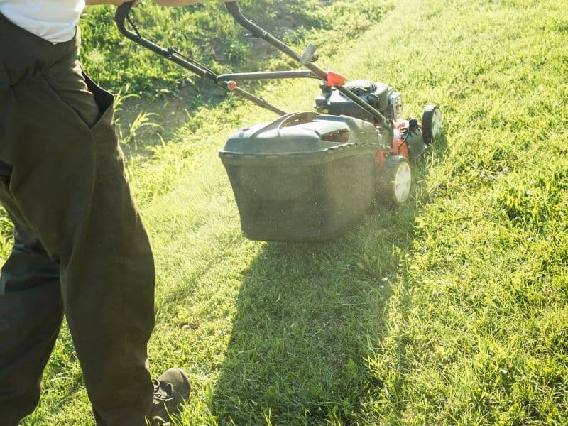 Man mowing uphill