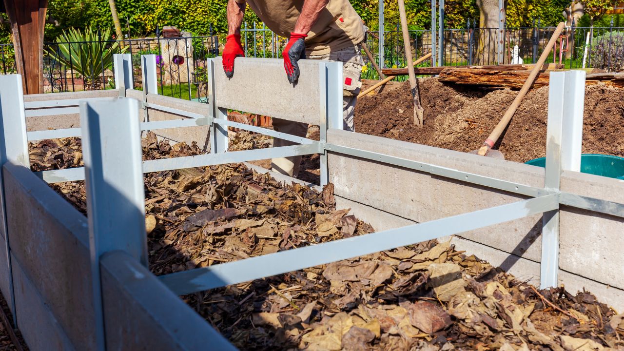 Construction of a raised bed with Edging Stones and double T steel profile filling with rough mulch and ground in Residential garden, private vegetable garden. Landscape design in home garden.