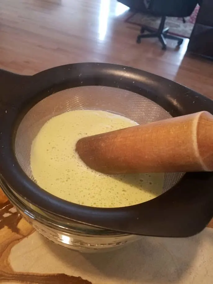 Straining asparagus soup to get out the fiber