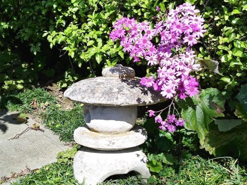 Pink flowers peeking from behind a pagoda