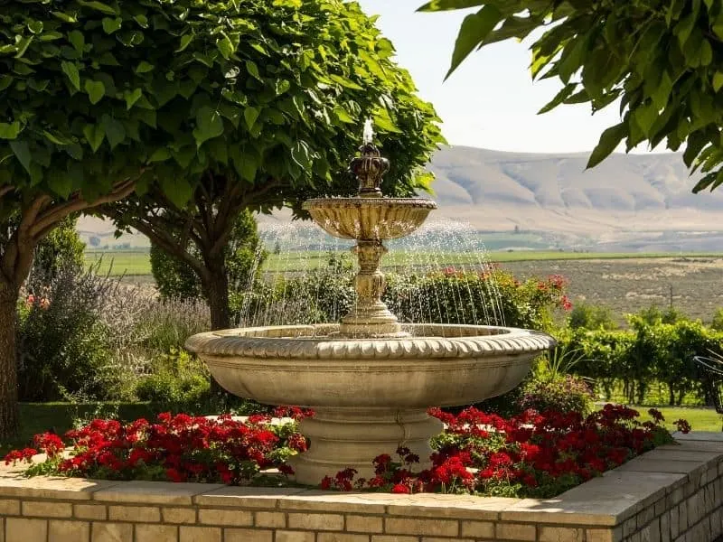 Garden fountain in the middle of a flower bed