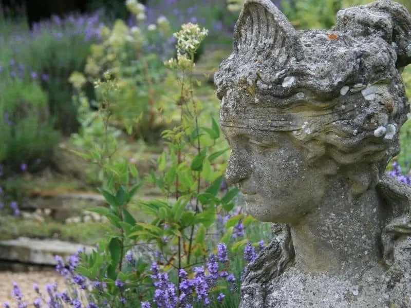Old stone head statue in the garden