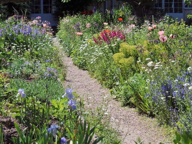 Gravel path through flower garden 