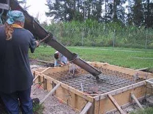 Pouring concrete for the greenhouse base