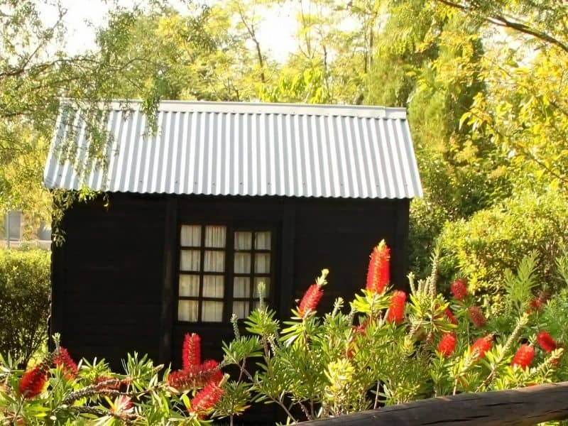 Brown storage shed with centrally located window