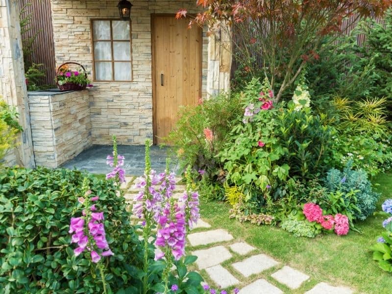 A cozy backyard with stone walkway and perennial flowers