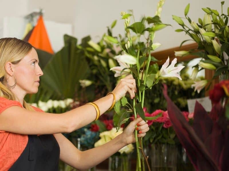 arranging flowers, tallest in the back