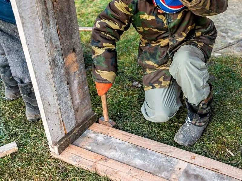 man building a box to use as a cold frame