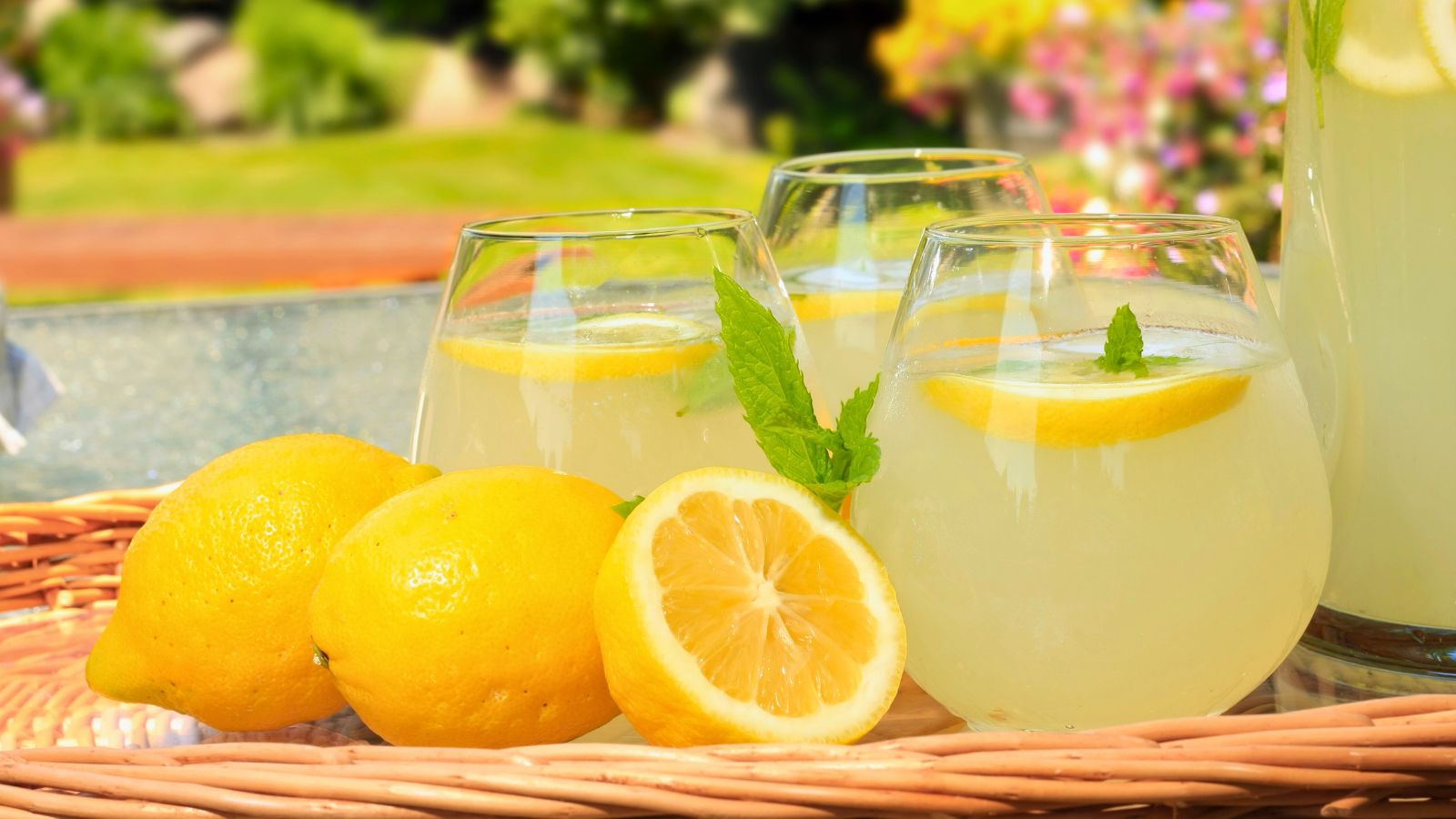 fresh lemons and lemonade on a tray.