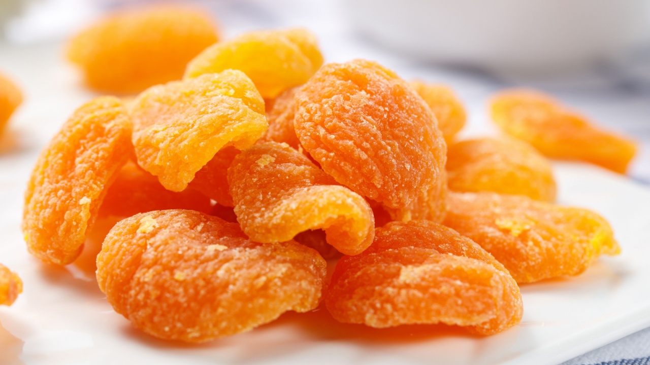 Dried yellow peach fruit on a white background