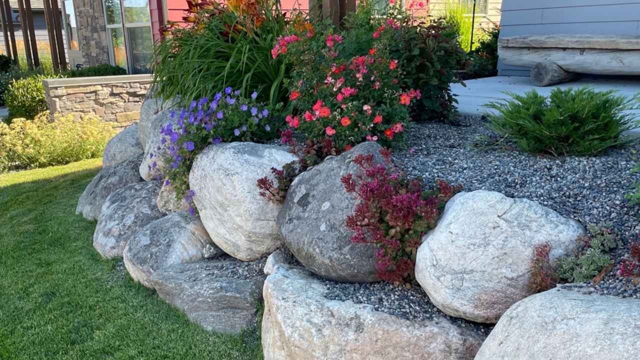 Incredible dry laid, stacked boulder, wall at a private residence. Landscaping added above the wall and in pockets of the wall.