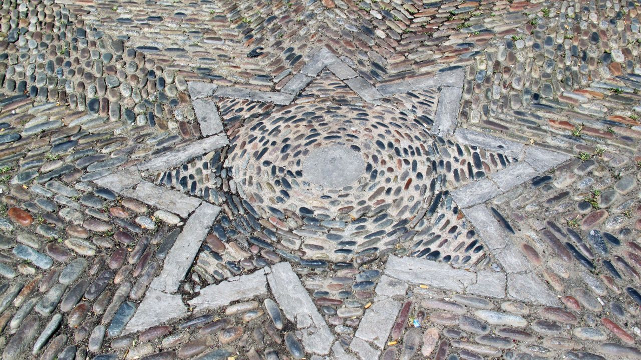 Spain, Girona, floor laid pebbles star
