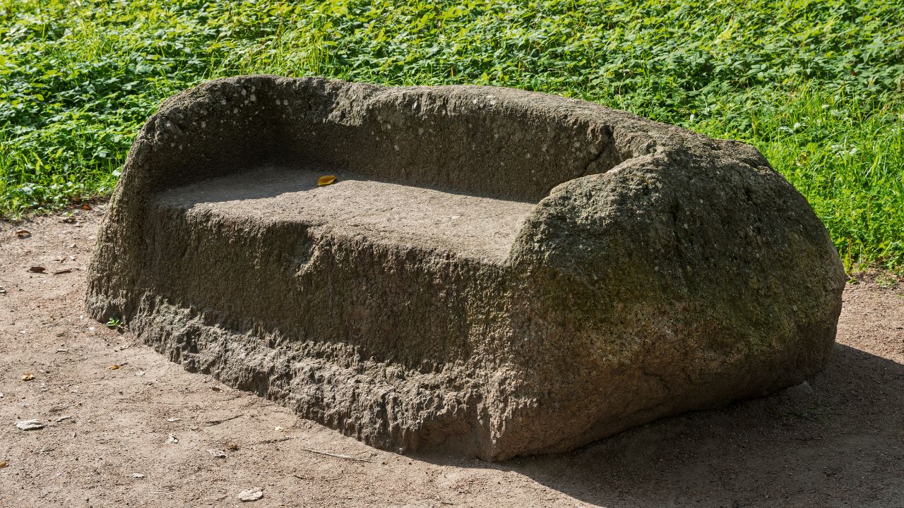 "Stone sofa" in the park of the Suida estate. Suida, Leningrad region, Russia. Historical landmark. The stone sofa was carved from a boulder in the 18th century by order of Abram Petrovich Gannibal. Boulders used as chair, seat, seating boulder