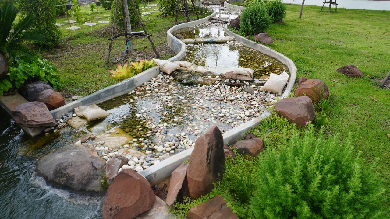 Pebble fountain in the garden, close-up of stones. Gravel water fountain.