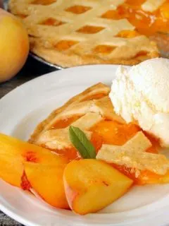 a piece of peach pie and a dollop of ice cream