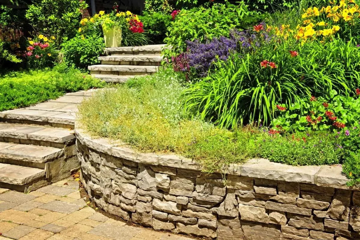rounded retaining wall with a colorful garden above it 