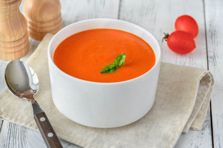creamy tomato soup in a white bowl
