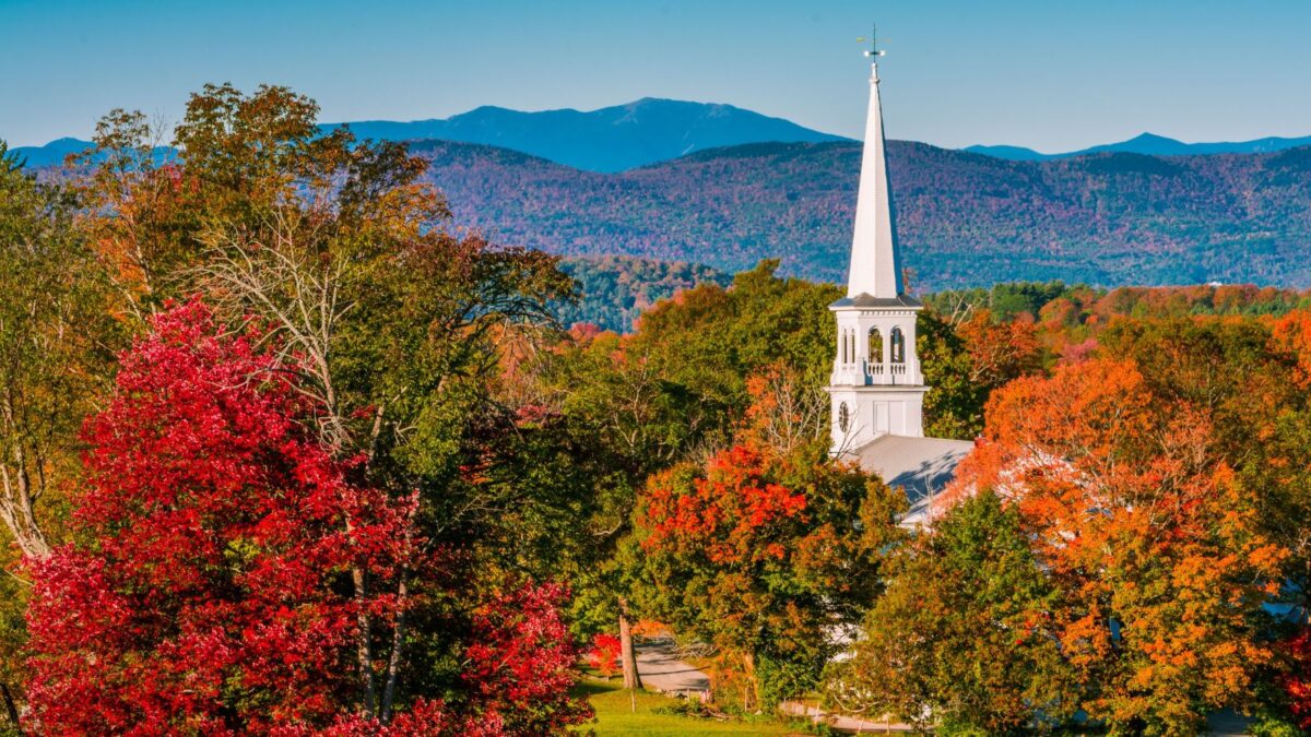 A church in the mountains of Peacham, Vermont, with fall foliage.