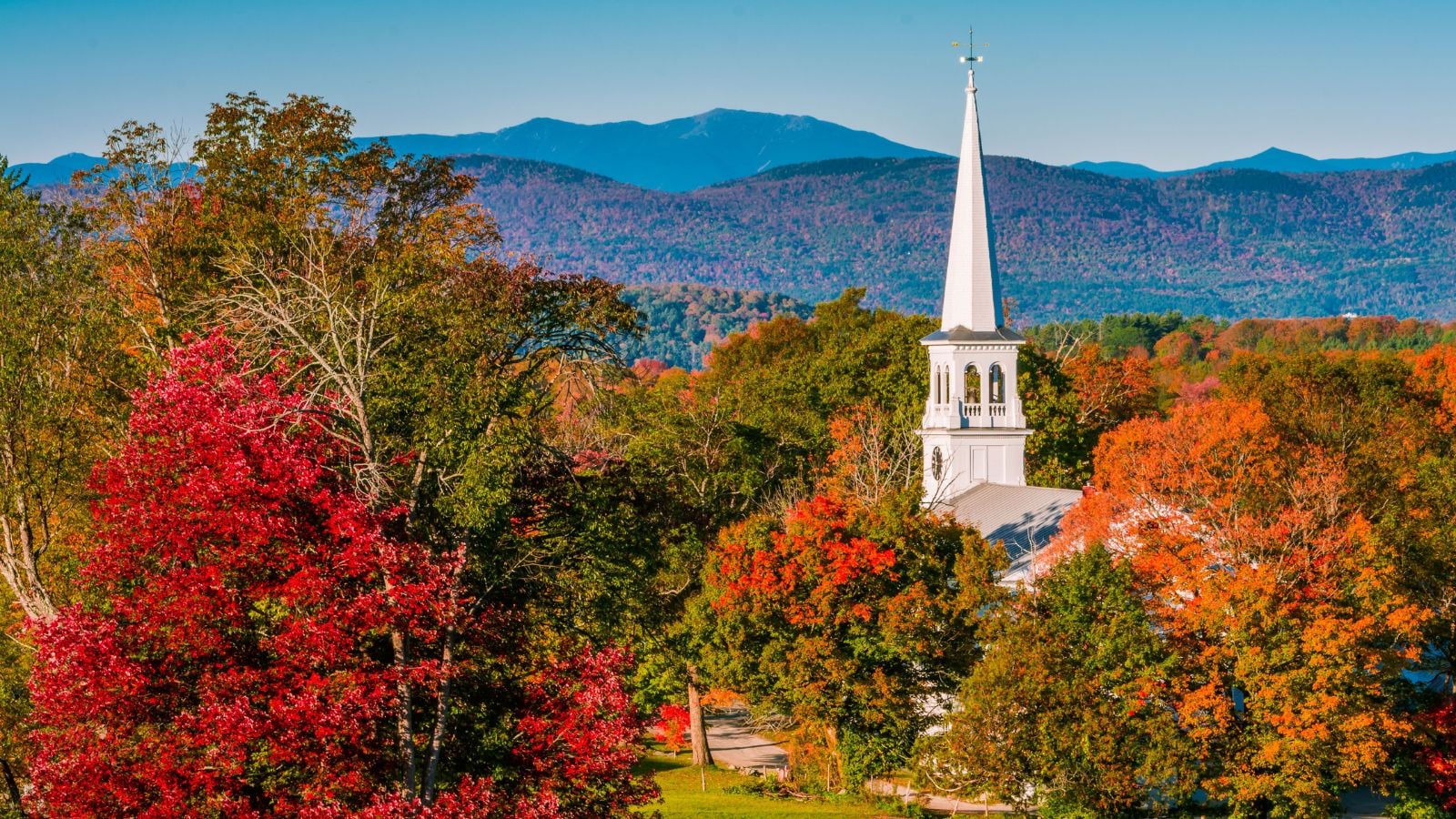 A church in the mountains of Peacham, Vermont, with fall foliage.