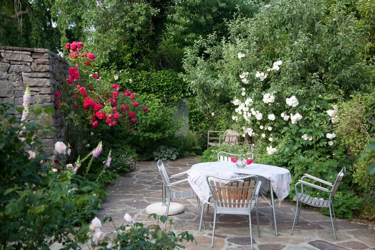 patio surrounded by spilling flowers