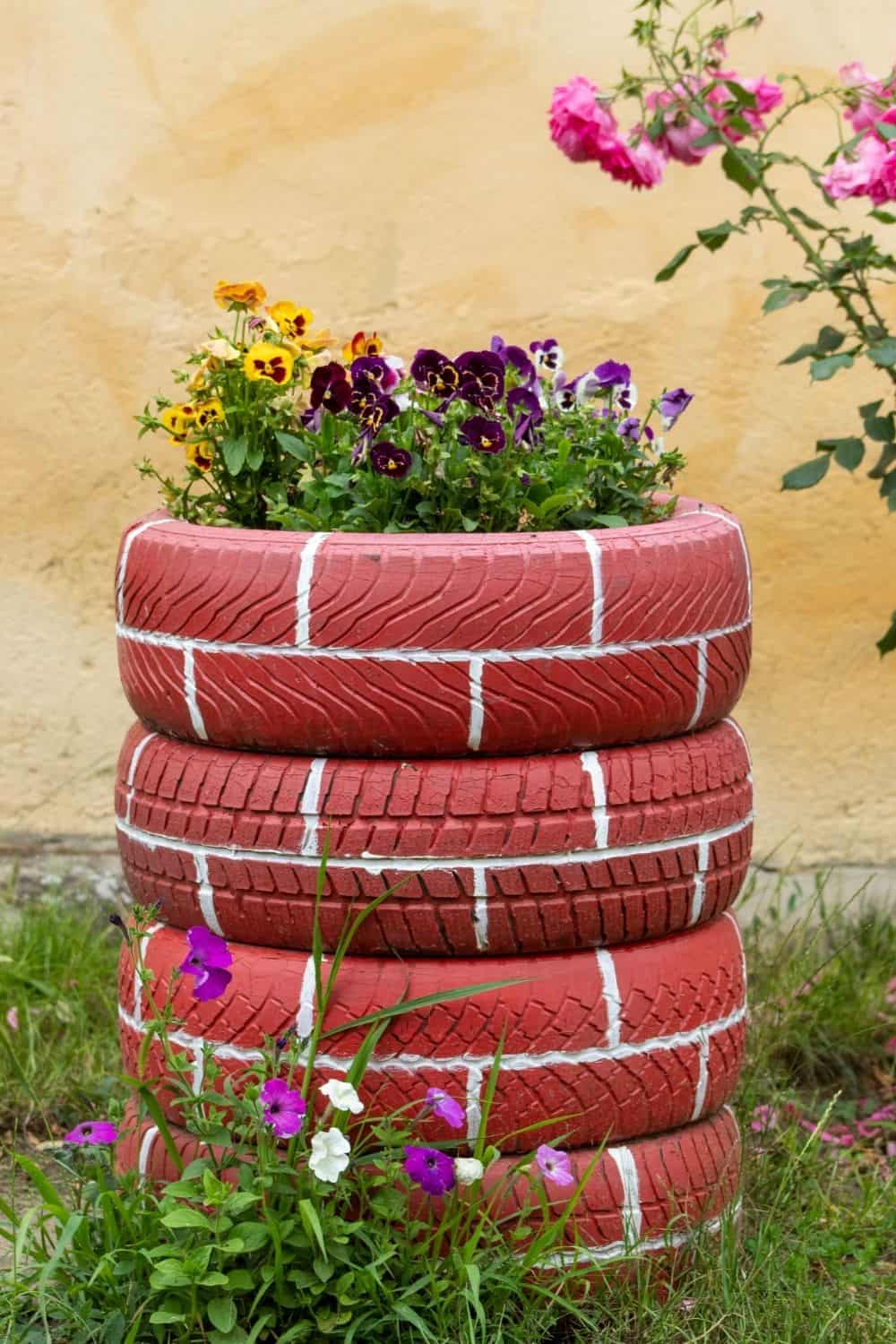 brick colored tire tower with flowers