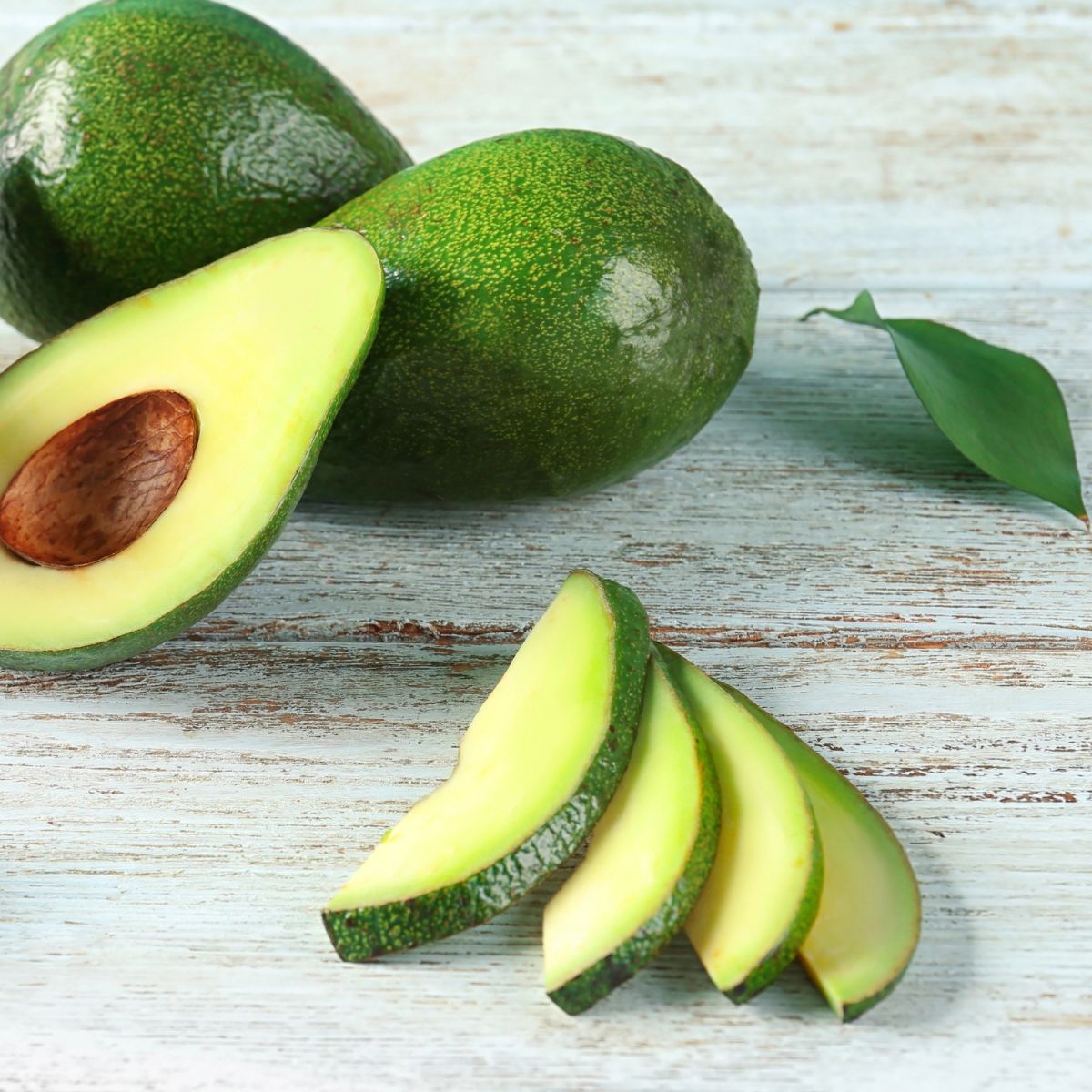 fresh sliced avocado on a wooden table.