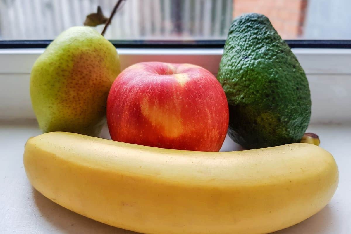 pear, apple, avocado and banana on the table